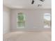 Large bedroom with ceiling fan, neutral carpet, plenty of natural light from numerous windows at 852 E Mountain View Rd # 18, San Tan Valley, AZ 85143