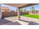 Covered patio offers great backyard views of the beautifully maintained synthetic lawn and block fencing at 852 E Mountain View Rd # 18, San Tan Valley, AZ 85143