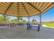 Covered community picnic area with blue picnic tables, perfect for gatherings at 852 E Mountain View Rd # 18, San Tan Valley, AZ 85143