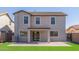 Rear exterior view shows a covered patio and lush backyard, perfect for entertaining or relaxing at 852 E Mountain View Rd # 18, San Tan Valley, AZ 85143