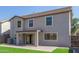Rear home exterior featuring a covered patio, backyard, and a well-maintained lawn at 852 E Mountain View Rd # 18, San Tan Valley, AZ 85143