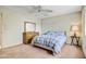 Cozy bedroom with comfortable furnishings, including a fan, dresser and side table at 858 S Portland --, Mesa, AZ 85206