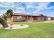 Charming brick home featuring manicured lawn and desert landscaping in a tranquil neighborhood setting at 858 S Portland --, Mesa, AZ 85206