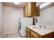 Functional laundry room includes washer, dryer, ample cabinetry, and vanity with sink at 858 S Portland --, Mesa, AZ 85206