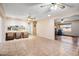 Open-concept living room with tiled flooring, seamless flow to kitchen and wood-look flooring in the front room at 858 S Portland --, Mesa, AZ 85206