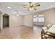 Large living room with tiled flooring, multiple ceiling fans, and neutral paint, offering a versatile space at 858 S Portland --, Mesa, AZ 85206