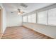 Sun-filled room with wood-look flooring, ceiling fan, and large windows offering abundant natural light at 858 S Portland --, Mesa, AZ 85206