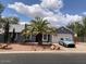 Charming single-story home with desert landscaping, a palm tree, and a blue sky backdrop at 9327 E Des Moines St, Mesa, AZ 85207