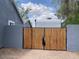 Tall wood and metal gate providing security and privacy to the backyard at 9327 E Des Moines St, Mesa, AZ 85207