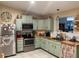 Traditional kitchen featuring stainless steel appliances and ample counter space with tiled backsplash at 9327 E Des Moines St, Mesa, AZ 85207