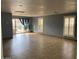Spacious living room with tiled flooring, bright windows, and sliding glass door at 9327 E Des Moines St, Mesa, AZ 85207