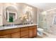 Bright bathroom with dual sinks, granite countertops, and a tiled walk-in shower at 945 N Pasadena -- # 62, Mesa, AZ 85201