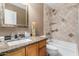 Neutral toned bathroom featuring granite countertops, updated fixtures, and a shower and tub at 945 N Pasadena -- # 62, Mesa, AZ 85201