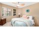 Bright bedroom with modern furniture, a window with blinds, a ceiling fan and decorative wall art at 945 N Pasadena -- # 62, Mesa, AZ 85201