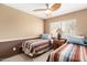 Bedroom featuring twin beds, a window with blinds, ceiling fan and wainscotting at 945 N Pasadena -- # 62, Mesa, AZ 85201