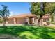 Well-manicured front lawn with attached garages, tile roof, and private walkway at 945 N Pasadena -- # 62, Mesa, AZ 85201