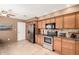 Well-equipped kitchen featuring stainless steel appliances, wooden cabinetry, and tile flooring for easy maintenance at 945 N Pasadena -- # 62, Mesa, AZ 85201