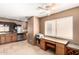 Open kitchen with stainless steel appliances and a desk area with granite countertops at 945 N Pasadena -- # 62, Mesa, AZ 85201