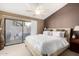 Bright main bedroom with sliding glass doors leading to the patio and a ceiling fan at 945 N Pasadena -- # 62, Mesa, AZ 85201