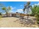 Expansive backyard showcasing the home's exterior, mature trees, and the potential for outdoor enjoyment at 9522 E Quarterline Rd, Mesa, AZ 85207