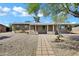 Charming single-story home featuring desert landscaping and a welcoming front porch at 9522 E Quarterline Rd, Mesa, AZ 85207