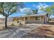 Quaint single-level home with desert landscaping and a shaded front entrance at 9522 E Quarterline Rd, Mesa, AZ 85207