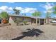 Inviting single-story home with xeriscaping and a covered porch entry at 9522 E Quarterline Rd, Mesa, AZ 85207