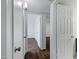 Hallway view showcasing wood-style tiled floors leading to bright, spacious bedrooms at 9522 E Quarterline Rd, Mesa, AZ 85207