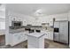 Modern kitchen with white cabinetry, stainless steel appliances, and island at 9522 E Quarterline Rd, Mesa, AZ 85207