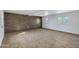 Large living room featuring wood accent wall, tile floors, and ample natural light at 9522 E Quarterline Rd, Mesa, AZ 85207