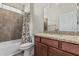 Bathroom with a vanity and granite countertop, bathtub with shower, and white toilet at 9550 E Thunderbird Rd # 149, Scottsdale, AZ 85260