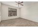 Neutral bedroom features a ceiling fan, window with blinds, and tile flooring at 9550 E Thunderbird Rd # 149, Scottsdale, AZ 85260