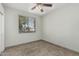 Neutral bedroom features a ceiling fan, window with blinds, and tile flooring at 9550 E Thunderbird Rd # 149, Scottsdale, AZ 85260