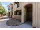 Inviting condo exterior featuring an arched entry, neutral stucco, and well-maintained landscaping at 9550 E Thunderbird Rd # 149, Scottsdale, AZ 85260