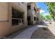 Exterior view showcasing the walkway, neutral tones, and well-maintained landscaping in a neighborhood setting at 9550 E Thunderbird Rd # 149, Scottsdale, AZ 85260