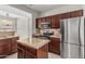 Well-equipped kitchen featuring stainless steel appliances, granite countertops, and dark wood cabinets at 9550 E Thunderbird Rd # 149, Scottsdale, AZ 85260
