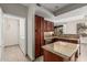 Open kitchen featuring granite countertops, stainless steel appliances, and dark wood cabinetry at 9550 E Thunderbird Rd # 149, Scottsdale, AZ 85260
