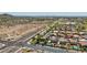 An aerial view of a neighborhood featuring homes with pools, landscaping and desert terrain at 9570 W Quail Track Dr, Peoria, AZ 85383