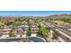 Wide aerial view showcases properties and streets surrounded by desert landscape offering a unique backdrop at 9570 W Quail Track Dr, Peoria, AZ 85383