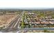 Aerial view of a suburban community with pools, well-maintained landscaping and mountain views at 9570 W Quail Track Dr, Peoria, AZ 85383