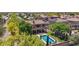 Beautiful backyard showcasing a sparkling pool, lush lawn, and the home's exterior with a balcony at 9570 W Quail Track Dr, Peoria, AZ 85383