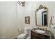 Charming powder room features a vanity with granite countertop, ornate mirror, and decorative chandelier at 9570 W Quail Track Dr, Peoria, AZ 85383