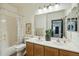 A bathroom with a double sink vanity, neutral decor, and a shower/tub combo at 9570 W Quail Track Dr, Peoria, AZ 85383