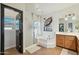 Bright bathroom features a separate shower and bathtub, vanity with wooden cabinets, and artwork at 9570 W Quail Track Dr, Peoria, AZ 85383