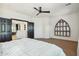 Bright bedroom featuring a ceiling fan, carpeted floors, and a large window showcasing the outside view at 9570 W Quail Track Dr, Peoria, AZ 85383