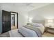 A bright bedroom features neutral tones, a ceiling fan and two bedside tables with lamps at 9570 W Quail Track Dr, Peoria, AZ 85383