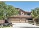Attractive two-story home offers a three-car garage, landscaping, and mature trees at 9570 W Quail Track Dr, Peoria, AZ 85383
