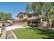 Front exterior showcases the landscaped yard, large driveway, and a three car garage at 9570 W Quail Track Dr, Peoria, AZ 85383