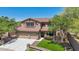 Attractive two-story home offers a three-car garage, landscaping, and charming desert trees at 9570 W Quail Track Dr, Peoria, AZ 85383