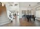 Bright foyer with staircase, stylish decor, leading to living spaces and a fireplace at 9570 W Quail Track Dr, Peoria, AZ 85383